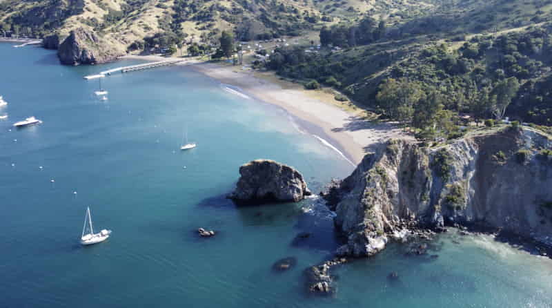 Long sandy beach and moored boats at White's Landing, Catalina Island