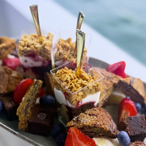 Gourmet dessert platter aboard AURORA featuring chef-crafted parfaits, fresh berries, and decadent baked treats.